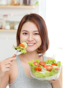 A woman eating a delicious salad