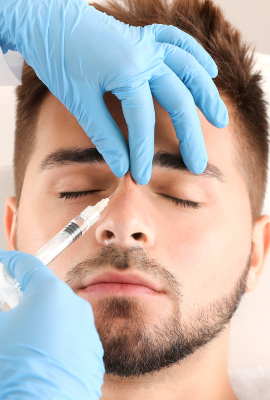 A man receiving an injection on the bridge of his nose